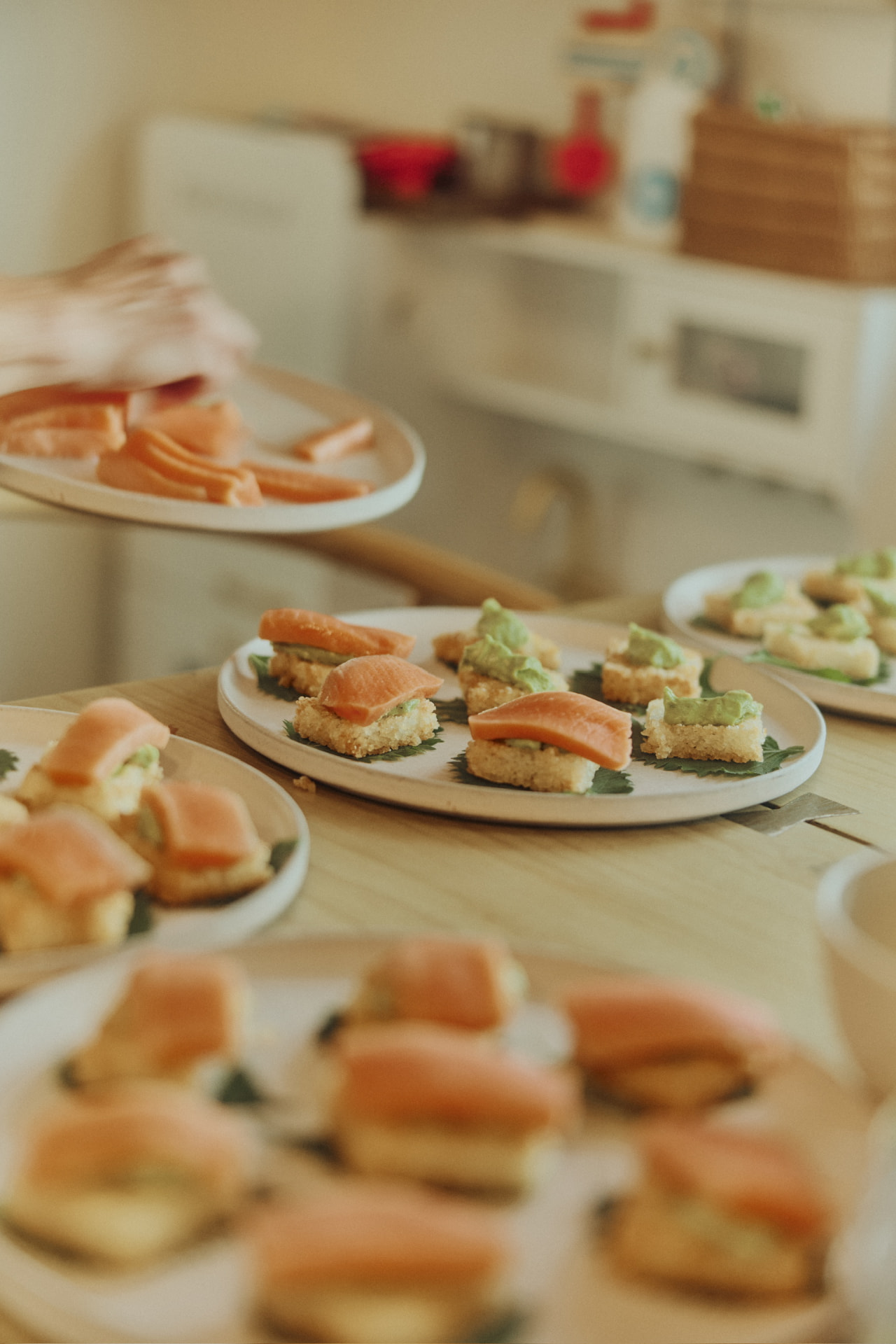 Plates of cured salmon canapés on shiso leaves